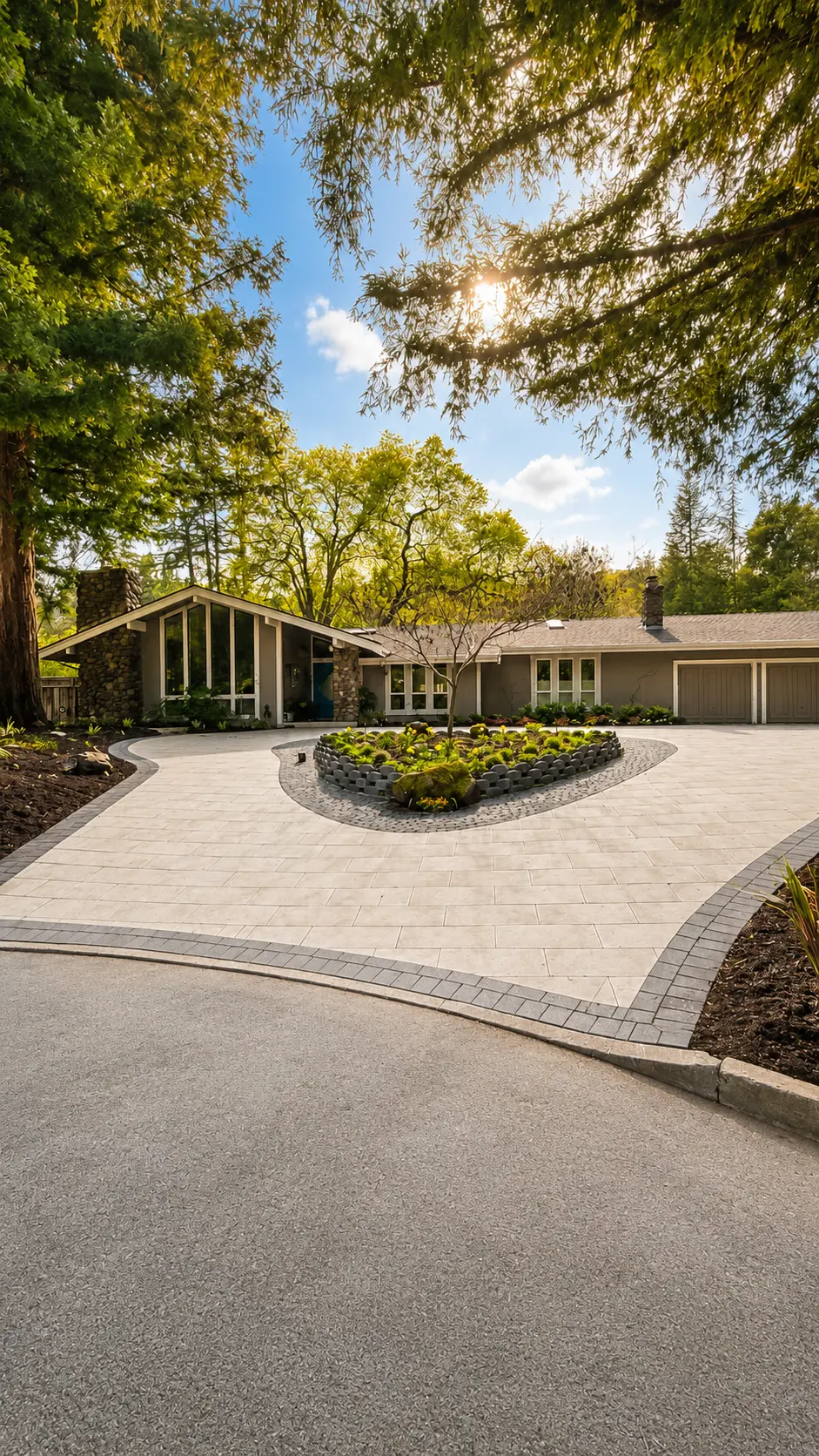 Circular paver driveway with heart-shaped planter in front of a mid-century home