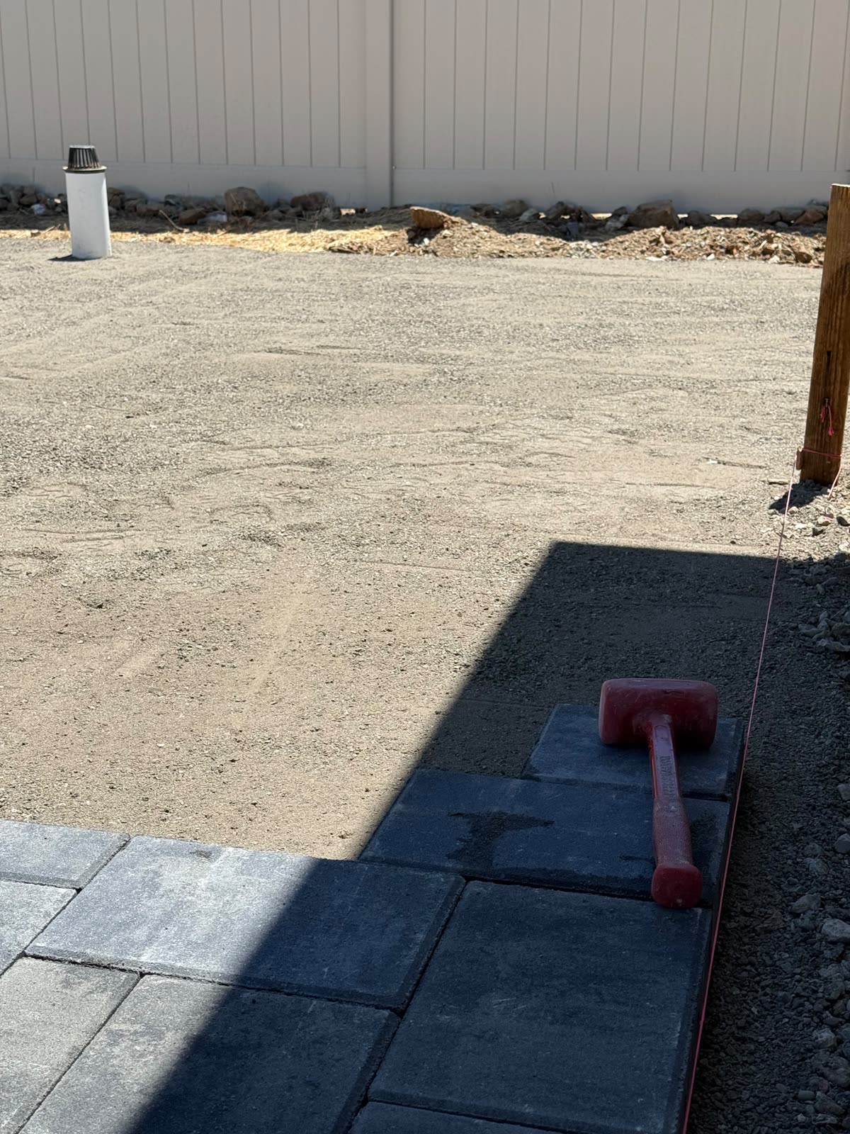 Paver installation in progress on a prepared, compacted base