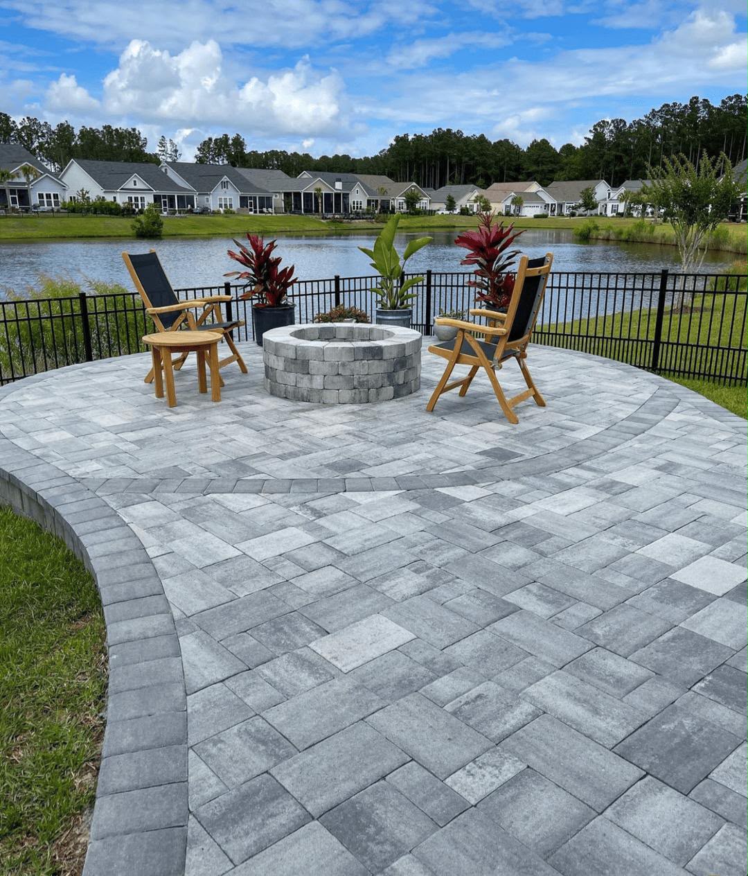 Paver patio with seat wall and landscaped backyard
